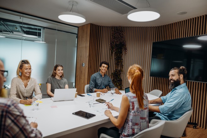Group of diverse business people and entrepreneurs sitting in the meeting room and talking