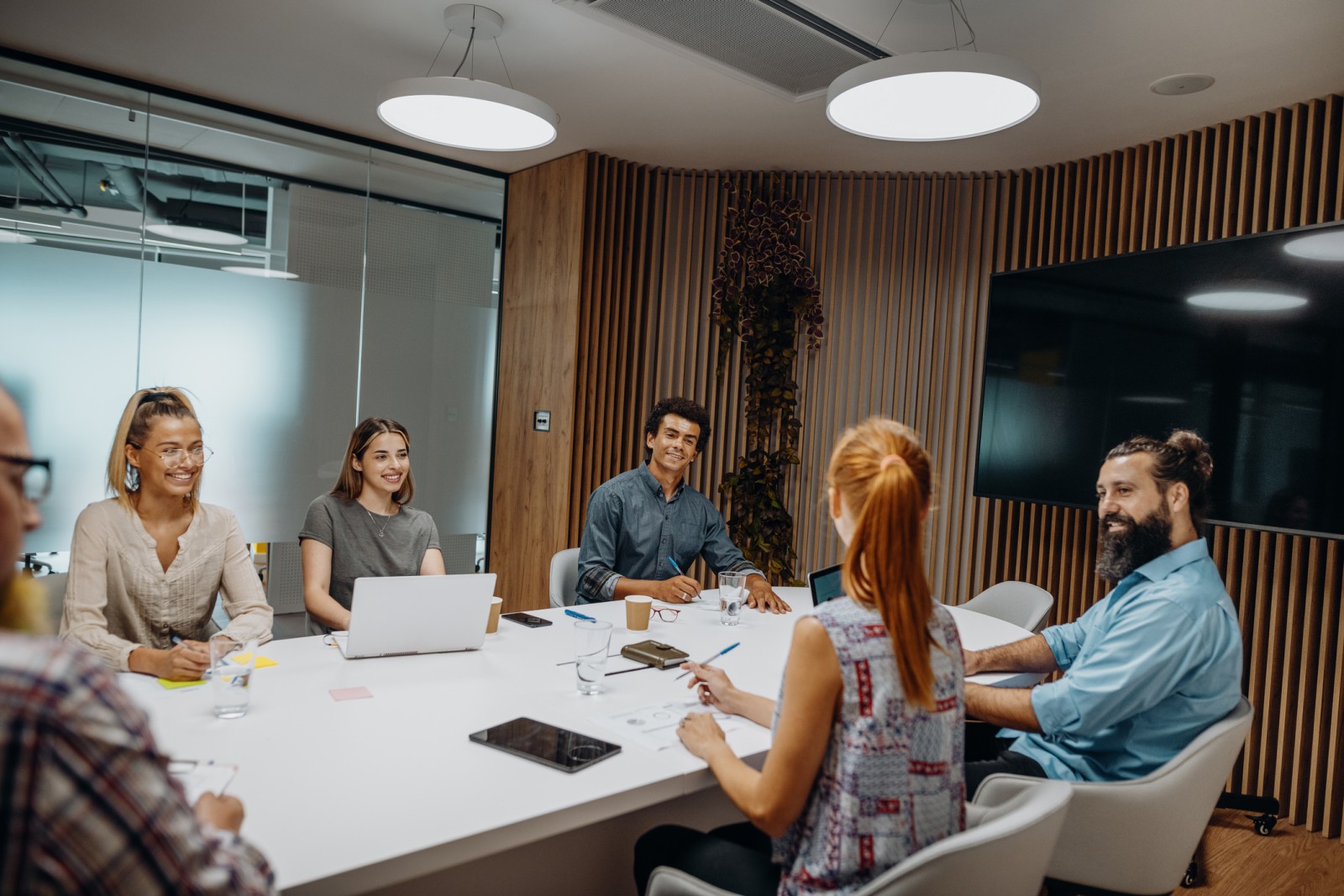 Group of diverse business people and entrepreneurs sitting in the meeting room and talking