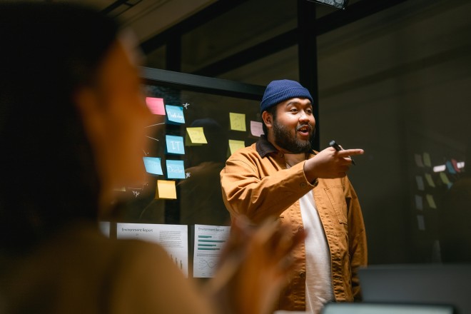 Asian People in a Business meeting are planning their marketing strategy with a glass board